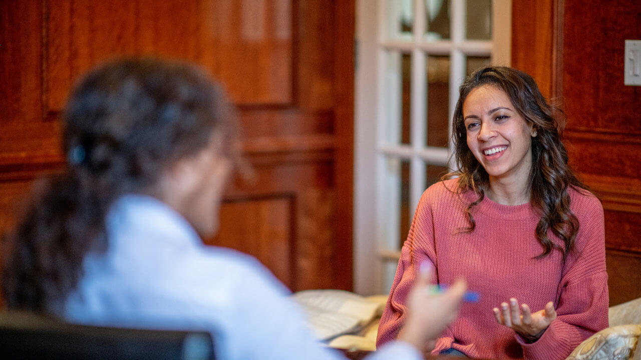 A woman speaks with a therapist during a personalized counseling session.